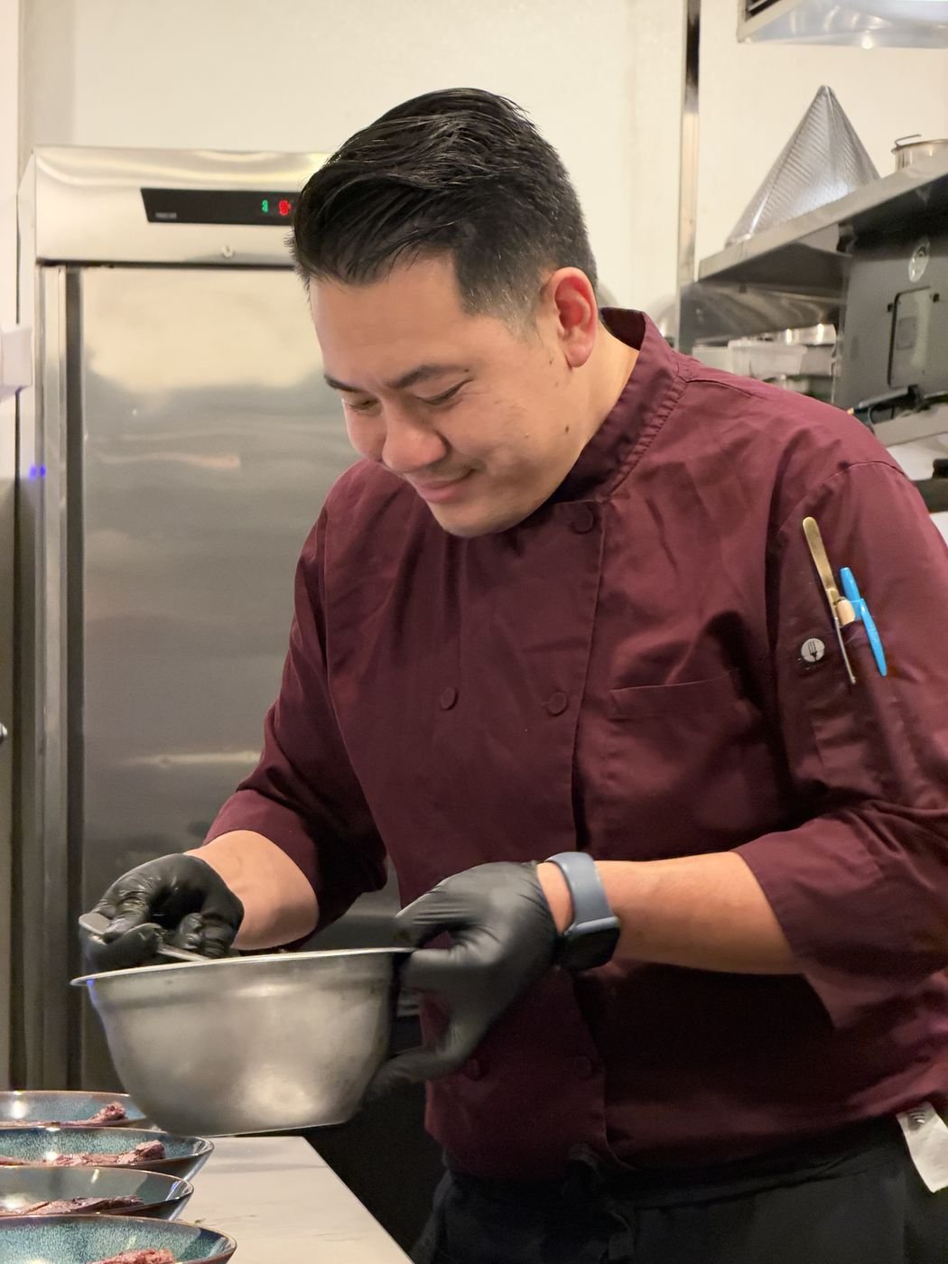 Executive Chef Danny Le finishing plates in the Chez Bacchus kitchen