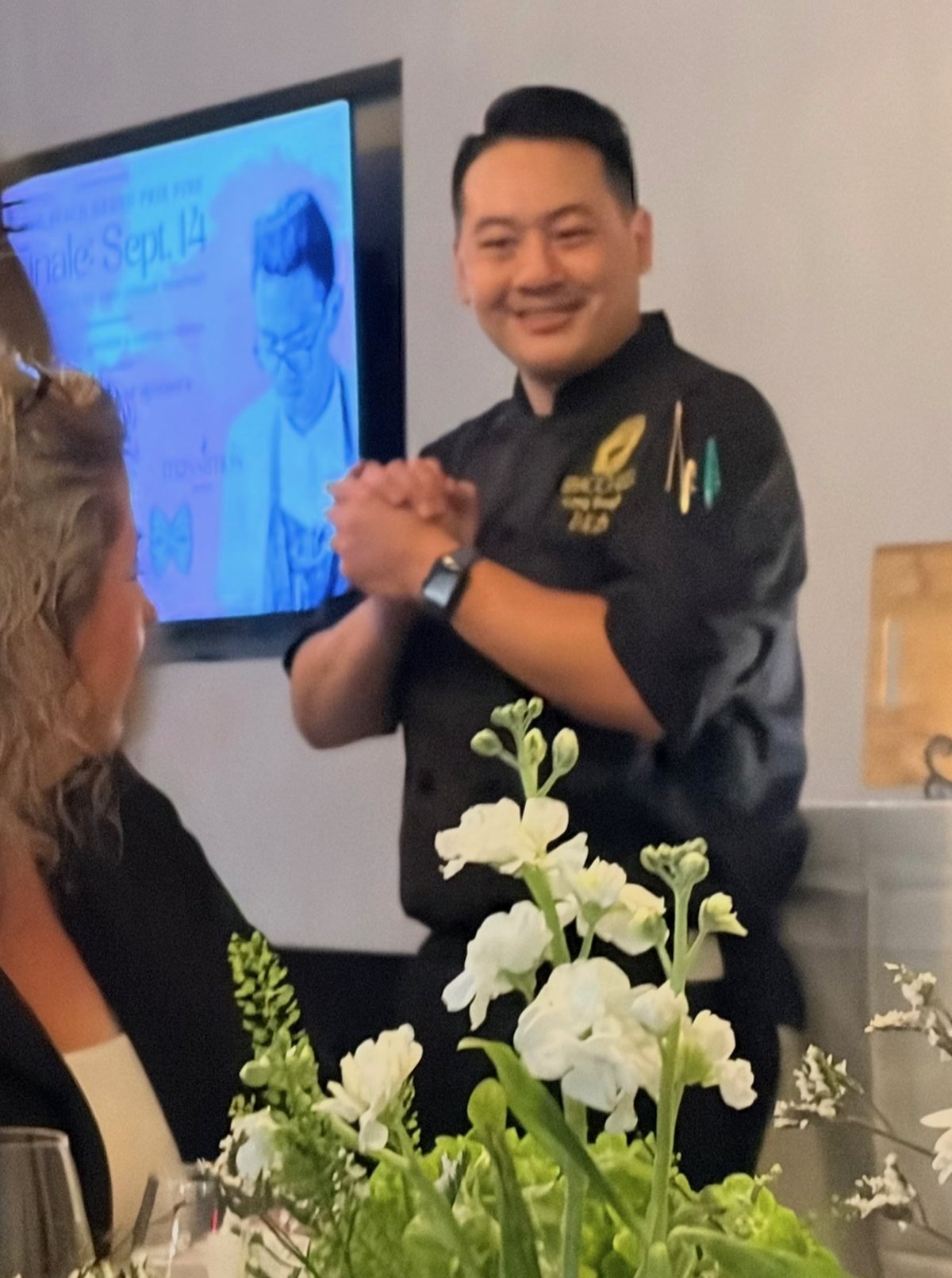 Executive Chef Danny Le, hands clasped and smiling, moments after the result was read at the Long Beach Grand Prix Fixe finale